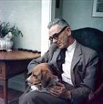 Jean-Paul Lemieux tenant son chien Bruno [between 1955-1963]
