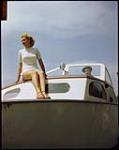 Betty Jackson, 16, aboard sailboat at Sarnia, Ontario Yacht Club. 1949.