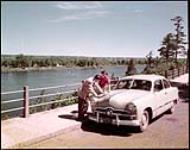 Tourists refer to map in Rockcliffe Park, Ottawa, Ont. June 1950.