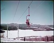 Girl on ski lift at Mont Tremblant in the Laurentian mountains, north of Montreal, P.Q. February 1950.