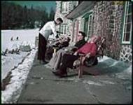 Winter tourists on the sun deck at the Chantecler, near Ste. Adele, in the Laurentian mountains.  janvier 1952.