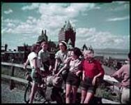 Group of five young female hostel workers. In the background is the Chateau Frontenac, Quebec City. August 1948.