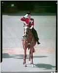 Her Majesty Queen Elizabeth II taking the salute in ceremony of Trooping the Colour. [ca. 1950].