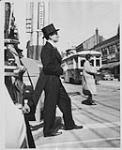 Man in a tuxedo and a top hat on a Toronto street [ca 1952?].
