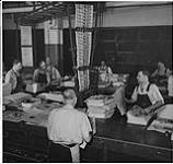 Globe and Mail, workers in the newspaper rooms, Toronto, men bundling newspapers for distribution [ca. 1939-1951]