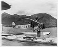 Two bush pilots gas up a pontoon plane prior to take off, Carcross n.d.