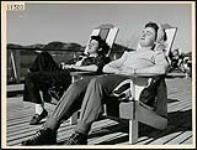 June Parker and Clare Everett winter tanning on the sun deck of the Ste. Adele Lodge March 1945