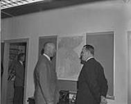 Former Korean Commanders Meet...A General Officer Commanding of the Commonwealth Division during the Korean War, Lieut.-Gen. Sir Michael West, left, met one of his former brigade commanders during a six day visit to Canada.  Gen. West reminiscences in front of a map of Korea with Maj. Gen. J.V. Allard, the present Vice-Chief of the General Staff, who was a Commander of the Canadian 25th Infantry Brigade.  Gen. West recently had the Canadian brigade in Europe serving under him when he was commander of the 1st Corps, British Army of the Rhine.