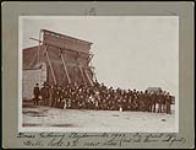 Xmas gathering, Lloydminster, N.W.T., in front of the new Hall, Scott and Co. store (football teams in front) 1903
