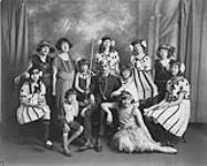 Wilson P. MacDonald with group of young actresses in costume [1925]