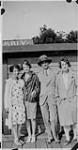 Wilson P. MacDonald with three women on a dock in the Muskokas [1926]