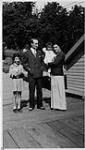 Wilson P. MacDonald with a woman and two children standing on a dock [1926]