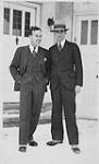 Wilson P. MacDonald and a man standing in front of a door [1926]