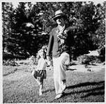 Wilson P. MacDonald and Ann MacDonald holding flowers [1944]