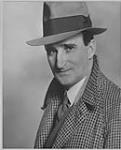  Wilson P. MacDonald wearing a hat and overcoat [1925]