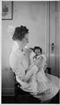 A nurse holding Ann MacDonald 1939