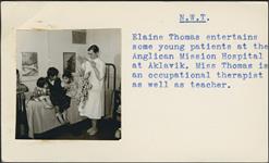 [Elaine Thomas entertaining three young patients with a puppet] [between 1955-1963]