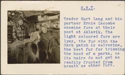 [Kurt Lang and Ernie Lacombe examine furs at their trade post] [between 1955-1963]