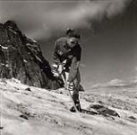 [Sissie Broda practices cutting steps in the ice on a mountain] [between 1953-1964]