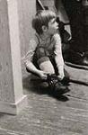 [Young boy lacing up his ski boot] [between 1953-1964]