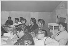 Group of adult Aboriginal students taking notes during class, Hobema décembre 1965