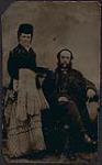 Portrait of a woman standing next to a seated man [ca. 1875-1910]
