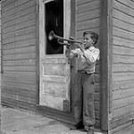 Pierre Paquin playing the trumpet, La Broquerie, Manitoba June 2, 1956.