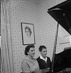 Family of Two Women Playing Piano [ca1954-1963]