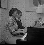Two Women Play the Piano [ca1954-1963]