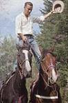 Cowboy debout sur deux chevaux, Manitoba juin 1956.