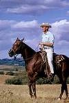 Profile portrait of cowboy on horseback September, 1962