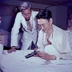 Harold Pfeiffer and a patient working on a carving at Charles Camsell Hospital [1955].