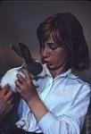 Sheila Murray holding a rabbit. Channel Island Zoo. Jersey [ca 1953-1964]