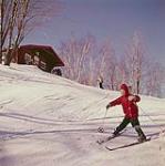 Boy skiing down slope at Mont-Tremblant, Laurentians, Quebec [Garçon descendant une pente en ski au Mont-Tremblant, dans les Laurentides, au Québec] février 1961