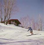 Man skiing down slope at Mont-Tremblant, Laurentians, Quebec [Homme descendant une pente en ski au Mont-Tremblant, dans les Laurentides, au Québec.] février 1961