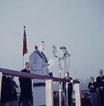 Queen Elizabeth speaking at a microphone during the royal visit to Canada, Oct. 1957. October 16, 1957.