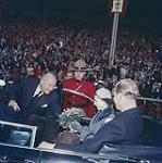 Queen Elizabeth and H.R.H. Prince Philip about to depart from Lansdowne Park, receiving flowers in car. Oct. 16, 1957.Ottawa, Ont.  [La reine Élizabeth et le prince Philip reçoivent des fleurs lors de leur départ en voiture du Parc Landsdowne, le 16 octobre 1957. Ottawa, Ontario] 16 octobre 1957.