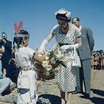 Her Majesty the Queen receives a bouquet from Verna Wyse at Nanaimo, B.C. July 1959