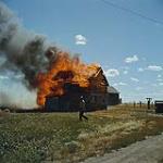 A farmer watching his barn burning out of control near Tuxford, Saskatchewan. juillet 1959