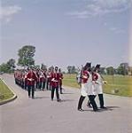 Soldiers marching during the official opening ceremonies at Upper Canada Village, on June 24th, 1961.   24 juin 1961.