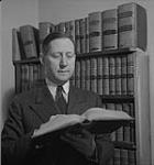 Toronto, unidentified man holding a book [between 1939-1951].