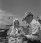 Winnipeg, 1940's. Unidentified Man Giving Unidentified Woman Money [between 1940-1949]