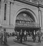 Winnipeg, 1940's. Crowd of Unidentified Men Leaving Canadian National Railways Union Station at the Excursions East and Pacific Coast Door [between 1940-1949]