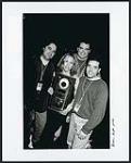 Sheryl Crow being presented with a double platinum award for her sophomore release "Sheryl Crow" after playing at the Majectic for 700 Molson Canadian Rocks Blind Date contest winners. Pictured with Sheryl from left to right are A&M/Island/Motown's Kirk Lahey (Atlantic Canada Promotion Rep), David Lindores (National Marketing Manager) and Shawn Marino (National Publicity and Video Manager). Decem 16 décembre 1996
