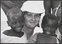 Tom Cochrane, an official endorser of World Vision Canada's 30 HOUR FAMINE fundraising program, visited the agency's feeding project in Morrua, Mozambique, which is helping these starving, young war victims. November, 1990 November, 1990