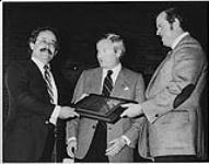 M. Norm Haines, président de la Broadcasters Association of Alberta (à droite), avec le premier ministre de l'Alberta, l'Hon. Peter Lougheed (au centre), remettent à Keith James, vice-président et directeur général des stations de radio CHFM et CKXL (Calgary), le prix Excellence in Broadcast Leadership 1979