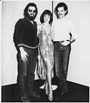 Portrait of Bob Saye and Brian Master of Q-107 with Solid Gold Girl after delivery of the label's first release, Even The Score by the band Toronto [entre 1980-1990]