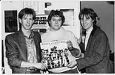 Dave Sinclair (left), lead singer and guitarist for Body Electric and CFTR assistant Music Director Henry Van Den Hoogen (centre) and Attic Director of Promotion Ralph Alfonso (right). Toronto [ca. 1985].