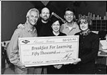 Doug Chappell (left, President of Mercury / Polydor Canada) presented Bonnie Cowan (right, editor of Canadian Living Magazine) with a cheque for $50,000 on the air at Toronto's CISS-FM. Cliff, Jacquie and Larry of the CISS morning team are also pictured. The cheque represented Shania Twain's proceeds to date from the Canadian sales of her CD single God Bless The Child, Twain donated the earnings  [entre 1997-1998].