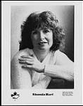 Press portrait of Rhonda Hart with her hand on her shoulder [between 1970-1975].